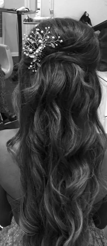 Black and white bridal updo with a hair accessory
